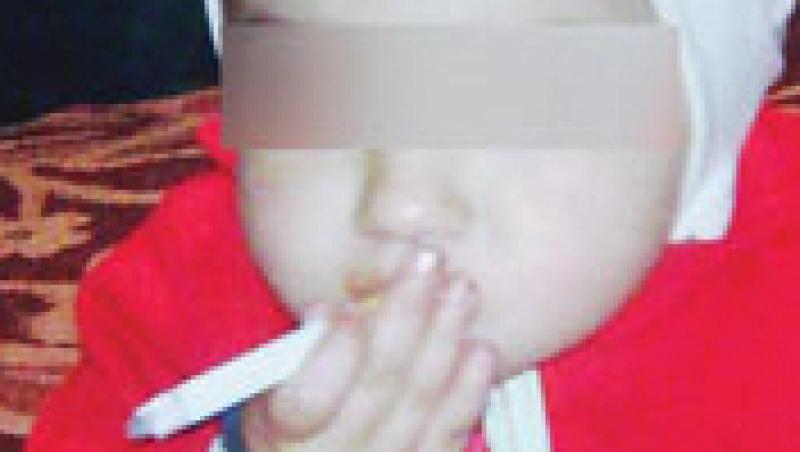 VIDEO! O fetita de 2 ani fumeaza si bea cafea, incurajata de mama ei