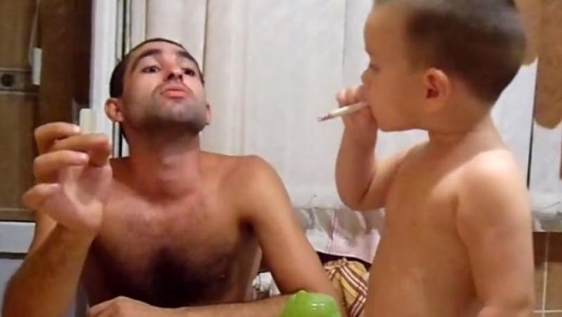 ȘOCANT! Fumează cot la cot cu fiul său de nici doi ani