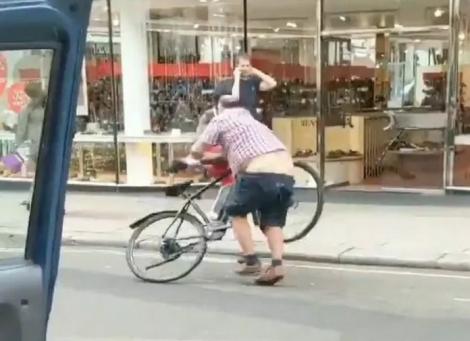 Un taximetrist a rămas fără pantaloni, după ce s-a luptat cu un biciclist, pe stradă! Momentul a fost filmat! Video