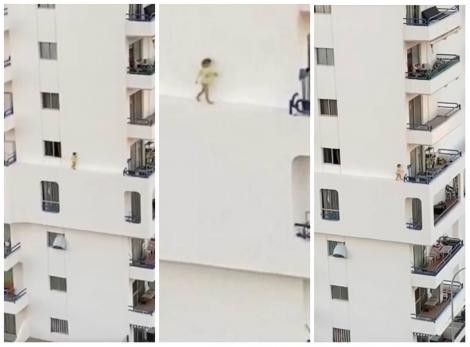 O fetiță s-a plimbat pe un perete al unui bloc, la etajul cinci! Era să cadă în brațele morții! Momentul terifiant a fost filmat! VIDEO