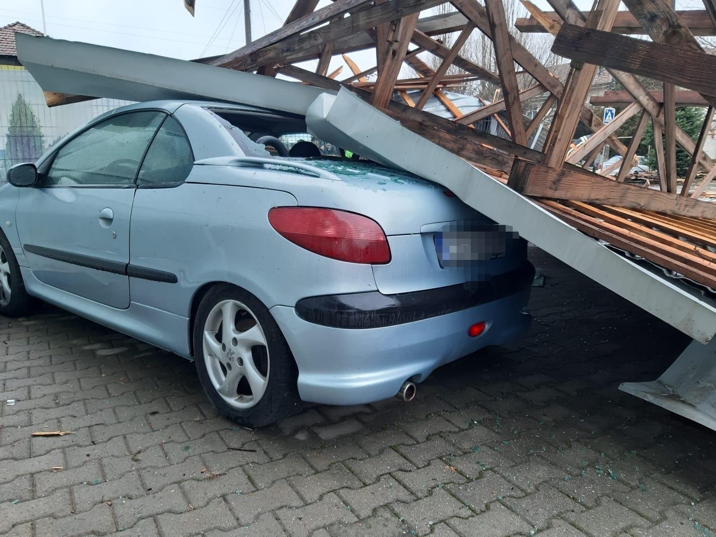 Acoperiş smuls de v&acirc;nt de pe un service auto şi prăbuşit peste maşini, la Caransebeş