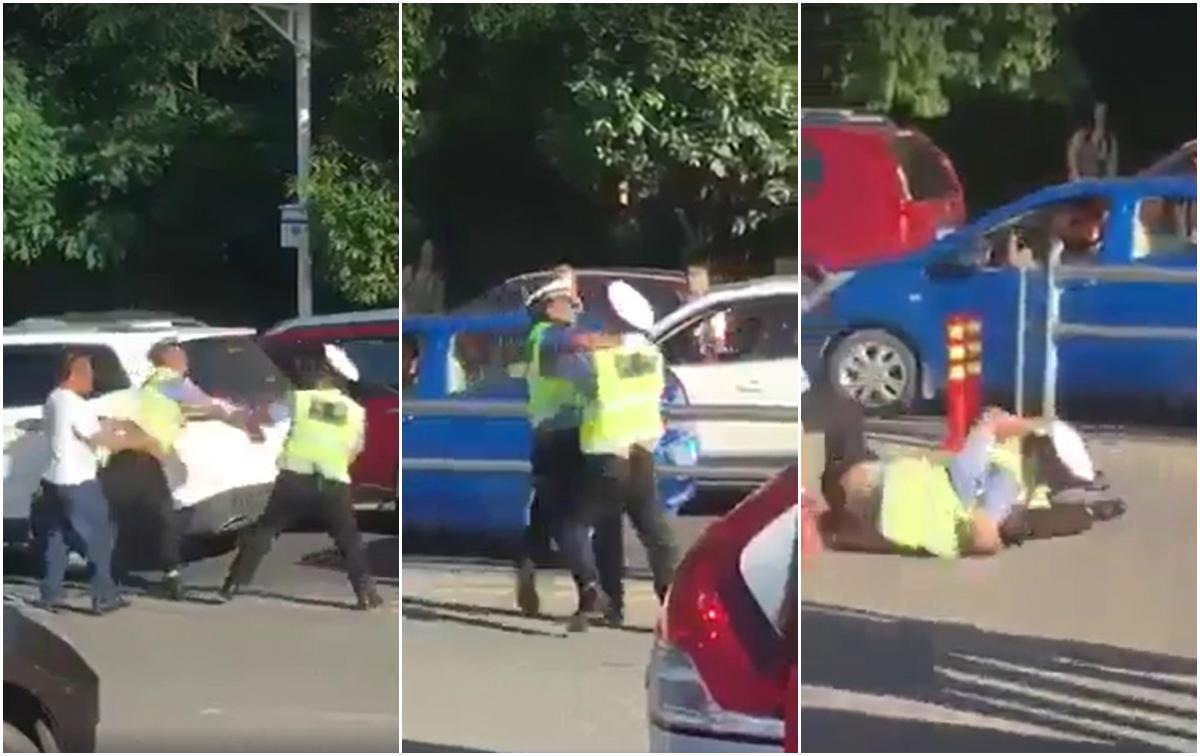 Doi polițiști s-au luat la bătaie, &icirc;n văzul tuturor! Oamenii legii și-au &icirc;mpărțit pumni și picioare, &icirc;n timp ce erau filmați de zeci de trecători