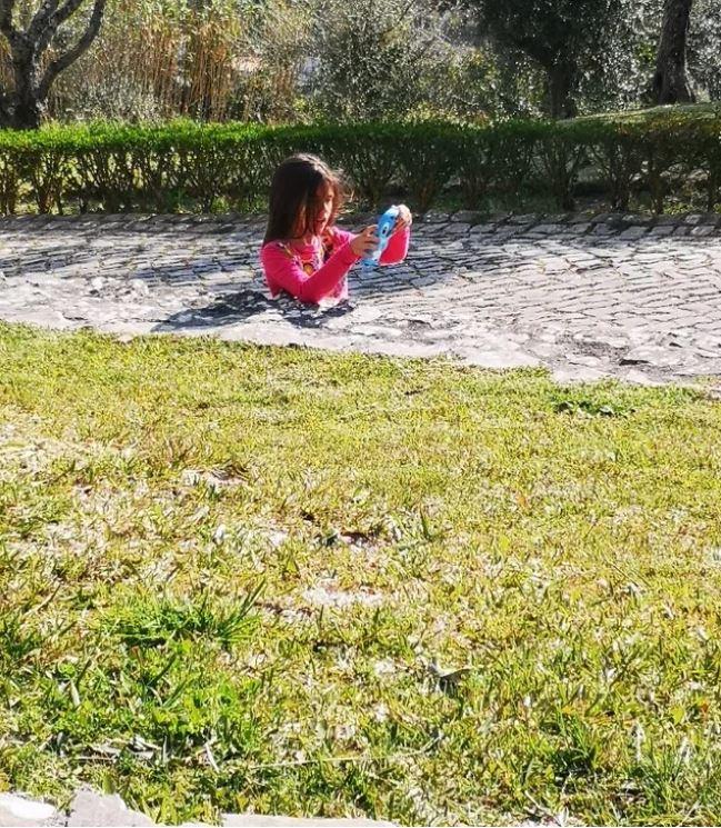 Fotografia cu o fetiță care pare &icirc;ngropată cu jumătate de corp &icirc;n cimentul unui trotuar face v&acirc;lvă pe Internet. Care e explicația