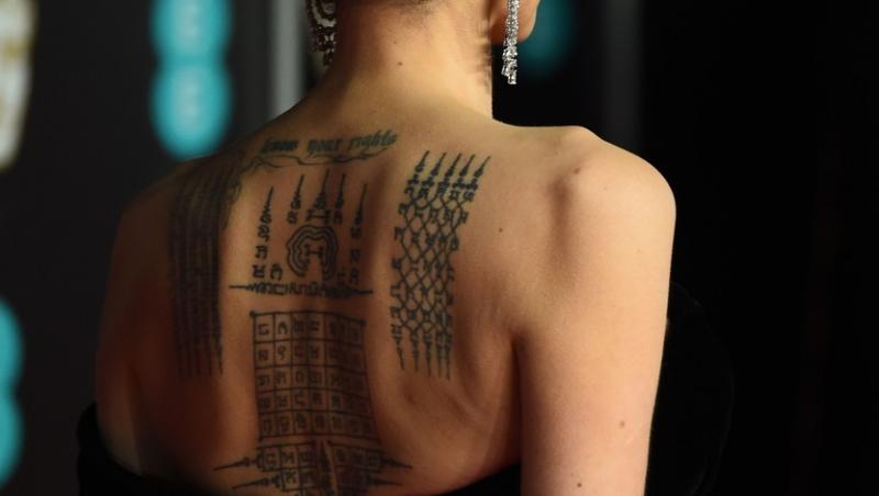 Angelina Jolie, din spate, i se văd tatuajele