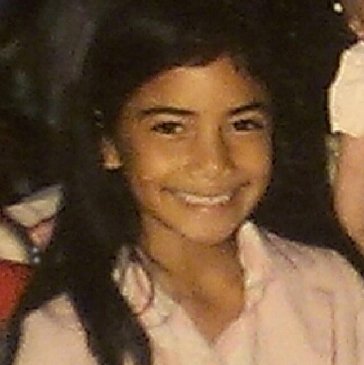 Nicole Scherzinger, când era mică, cu părul desprins și zâmbind