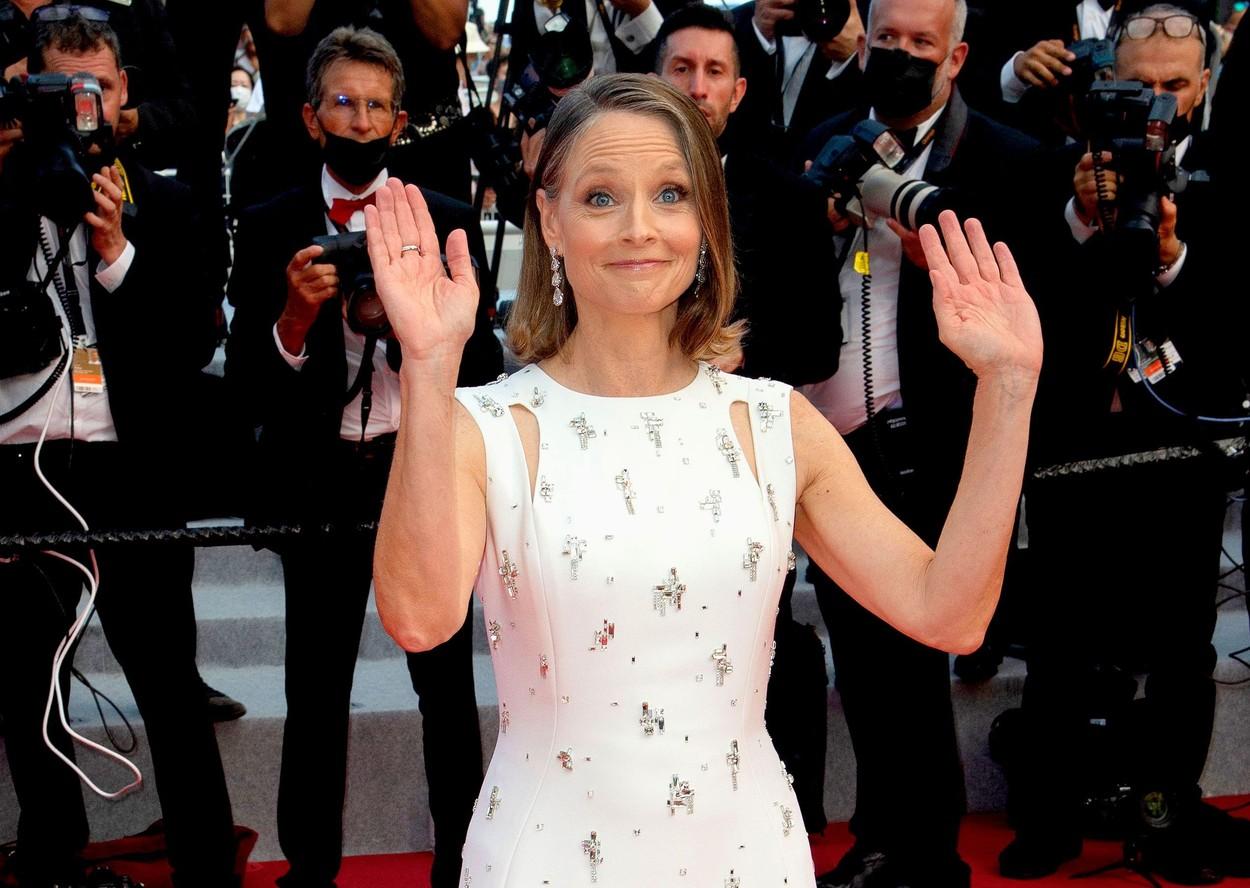 Actrița Jodie Foster va primi un premiu onorific în cadrul Festivalului de Film de la Cannes. În fotografie, este îmbrăcată într-o rochie albă, cu aplicații strălucitoare