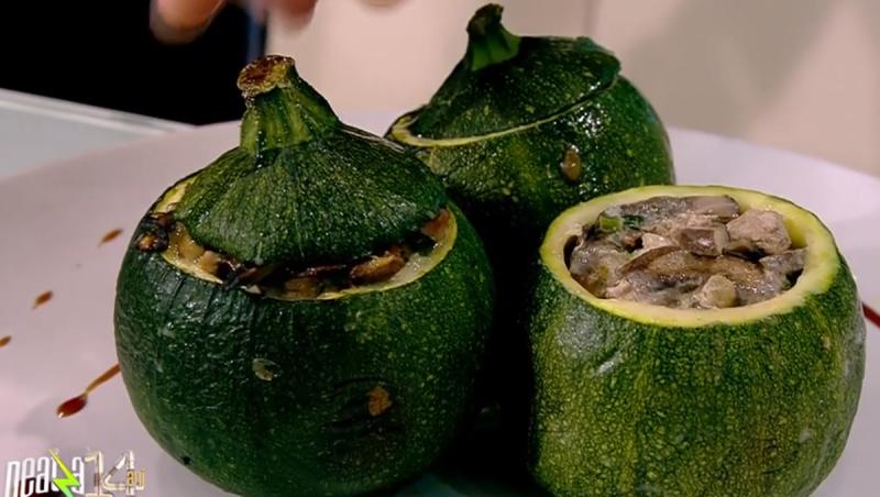 Three round zucchini stuffed with mushrooms and turkey meat on a plate