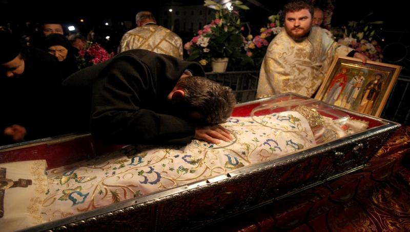Bărbat care se apleacă și se roagă la moaștele Sfintei Parascheva