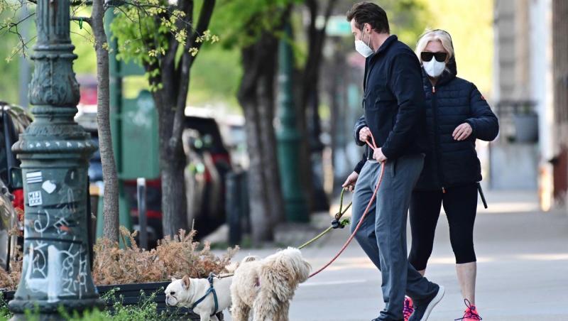 Hugh Jackman și Deborra-lee Jackman cu mască chirurgicală și ochelari de soare își plimbă câinii în New York