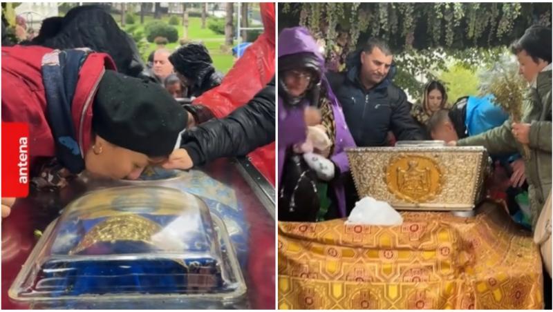 Oameni care se închină la racla cu moaștele Sfintei Parascheva