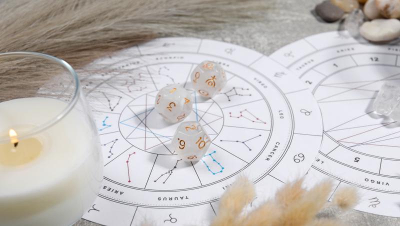 Harta horoscopului, zaruri cu numere și o candelă aprinsă