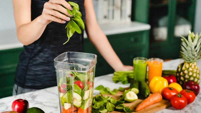femeie care prepara un smoothie sanatos