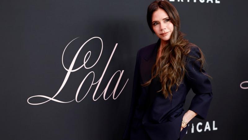 Victoria Beckham îmbrăcată într-un costum negru elegant