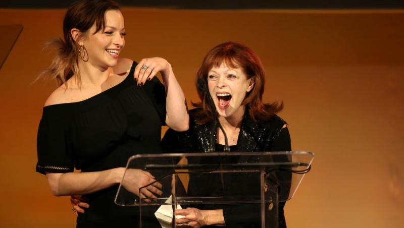 Frances Fisher alături de fiica ei, vorbind la microfon pe scenă, ambele îmbrăcate în negru