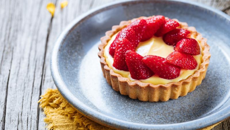 tartă cu căpșuni cu vanilie pe o farfurie albastră