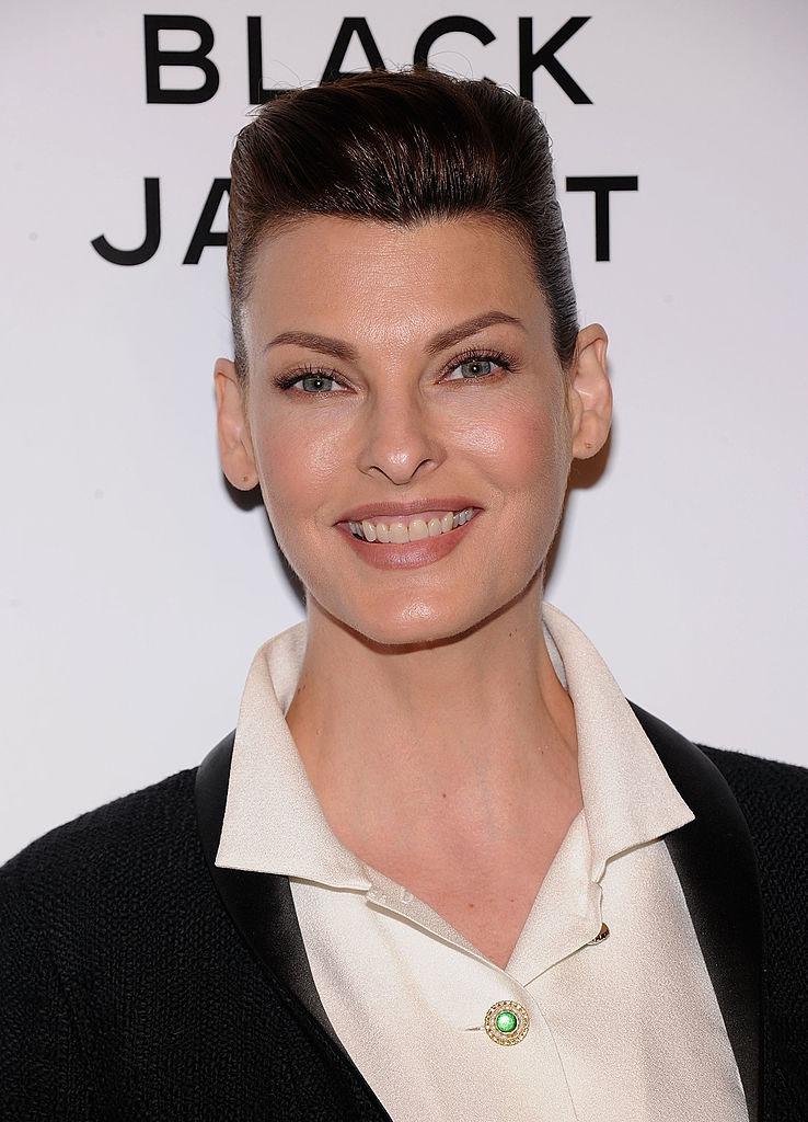 Linda Evangelista îmbrăcată cu un sacou negru peste o cămașă albă