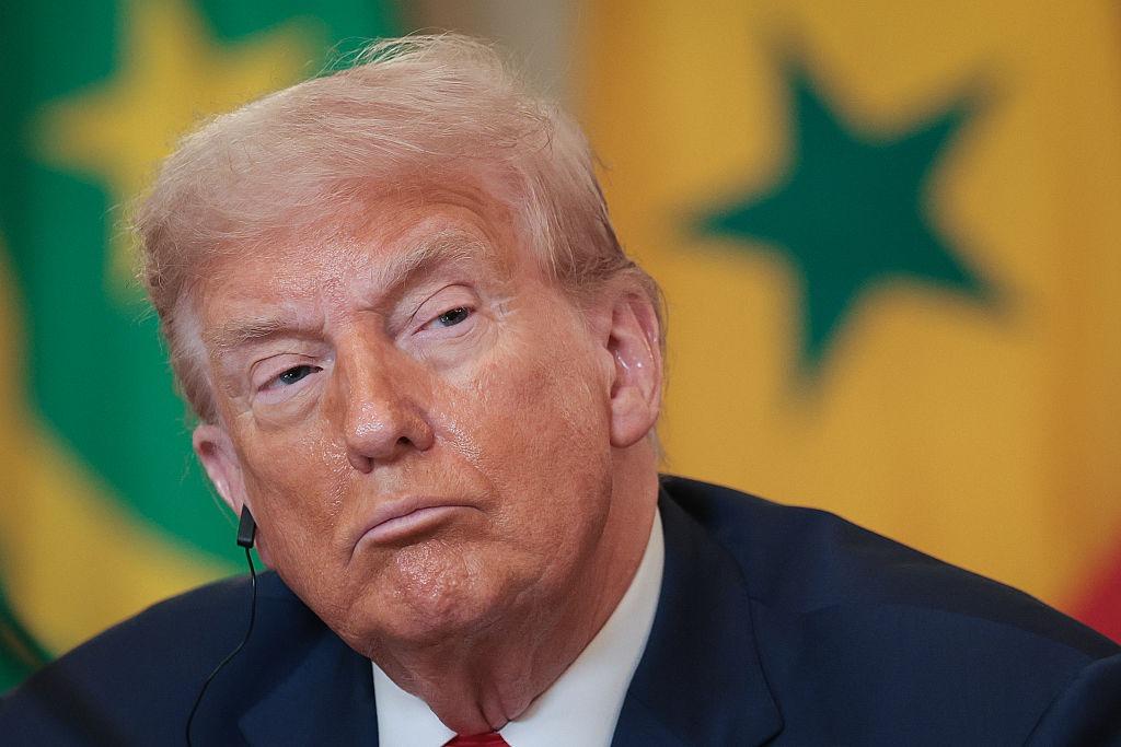 Donald Trump îmbrăcat cu un costum bleumarin și o cravată roșie