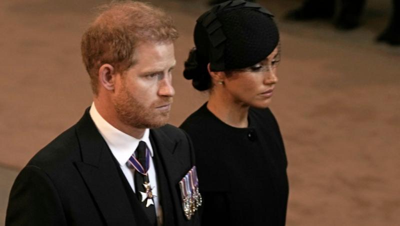 Prințul Harry alături de Meghan, Ducesă de Sussex, ambii îmbrăcați în negru