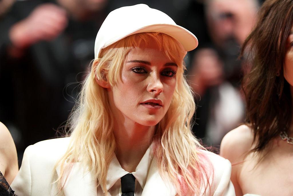 Kristen Stewart îmbrăcată cu un sacou alb și o șapcă asortată