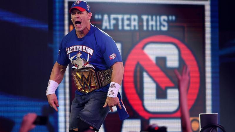 John Cena purtând centura WWE în ringul de luptă, aclamat de fani