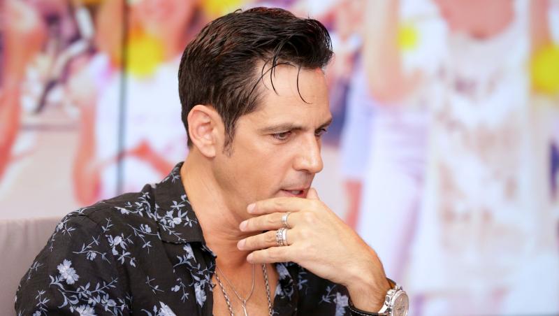 Ștefan Bănică Jr. îmbrăcat cu o cămașă neagră cu detalii albastre