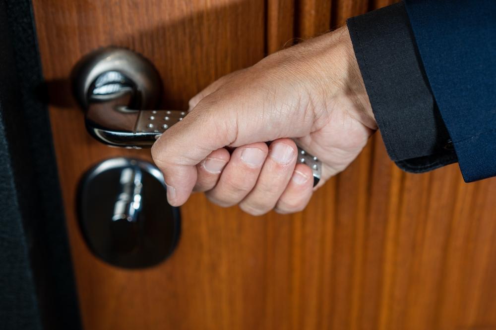 mana unui barbat care deschide usa