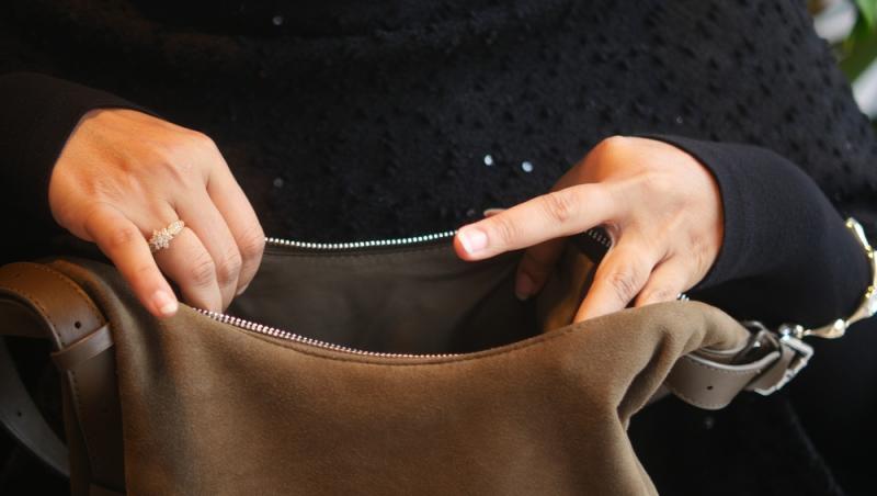 imagine cu femeie cautand intr-o geanta