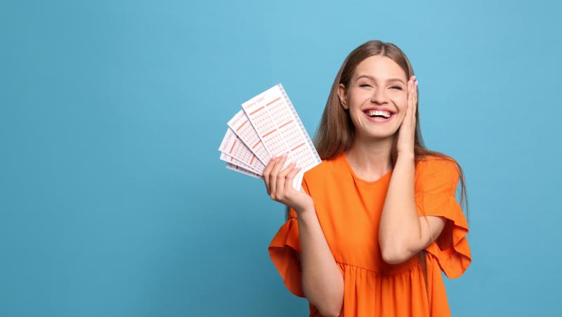 femeie bucuroasa, cu bilete loto