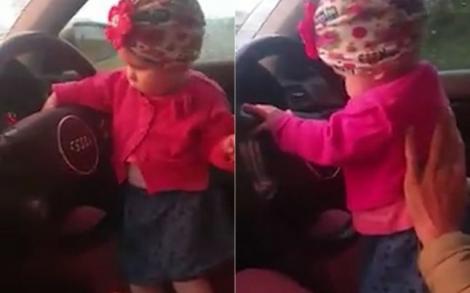 Inconștiență maximă, nu glumă! Un bărbat a fost filmat în timp ce conduce cu fetița lui în brațe: ”Uită-te în față la drum. Prinde volanul și condu!”