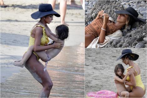 Mădălina Ghenea, surprinsă de paparazzi internaționali la plaja cu fiica, în compania unui bărbat necunoscut