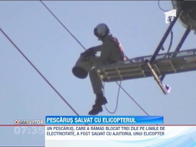 Un pescarus a fost salvat de un elicopter de pe liniile de electricitate