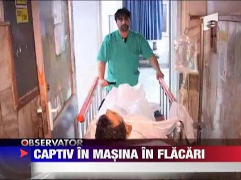 Captiv in masina in flacari