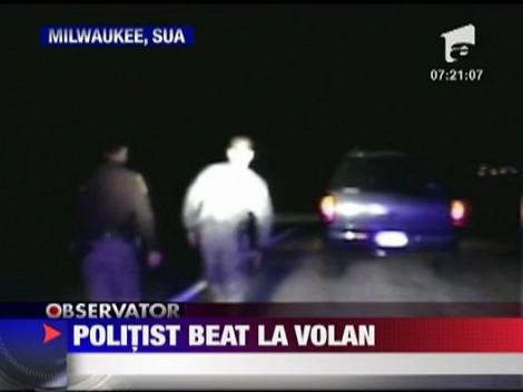 Politist beat la volan