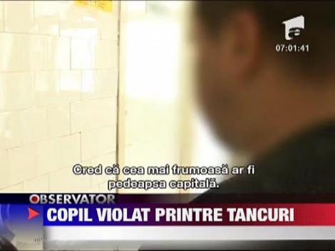 Copil violat printre tancuri