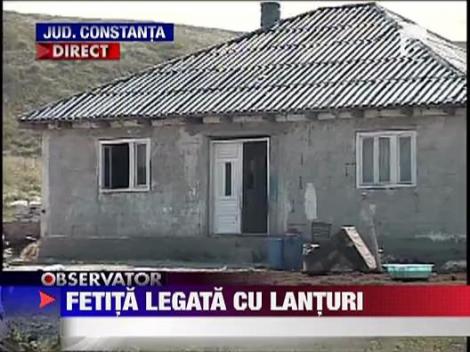 Fetita de 12 ani, tinuta in lanturi