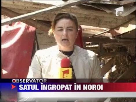 Sat ingropat in noroi
