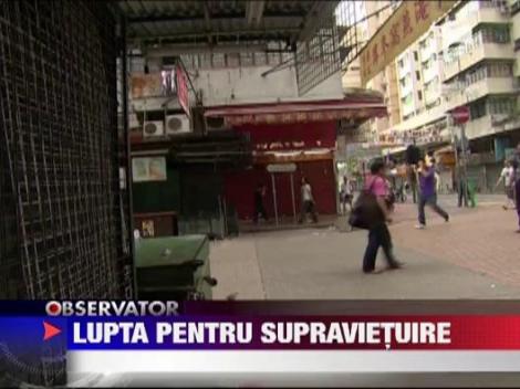 Oamenii care cauta prin gunoaie, in pericol din cauza recesiunii