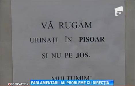 Revolta in Parlament! Femeile de serviciu au recurs la afise care sa ii invete pe alesi cum sa foloseasca... pisoarul