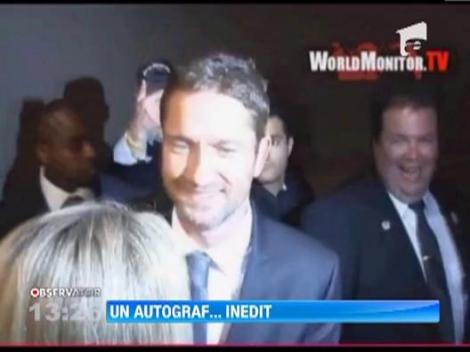 Gerard Butler a dat un autograf pe fruntea unei fane