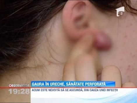 Pe masa de operatie dupa ce si-a facut gauri in urechi