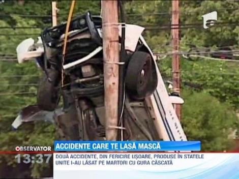 O masina de politie a ajuns in pozitie verticala pe un stalp de electricitate