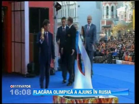 Flacara olimpica a ajuns in Rusia