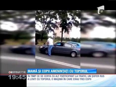 Mamă și copii amenințați cu toporul în trafic