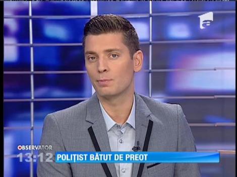 Poliţist bătut de preot