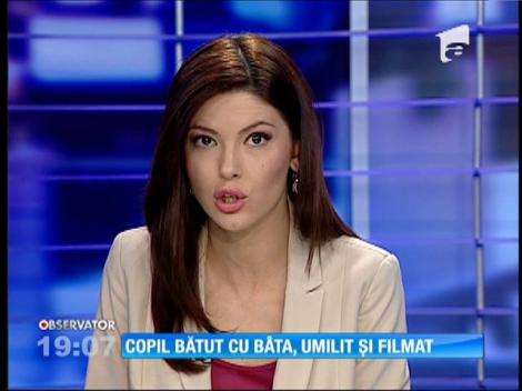 Copil bătut cu bâta, umilit și filmat