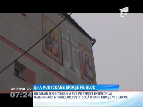 Și-a pus două icoane şi o cruce, imense, pe faţada blocului