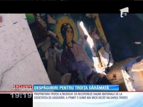 O troiţă distrusă, motiv de război între o mamă îndoliată şi firma de asigurări