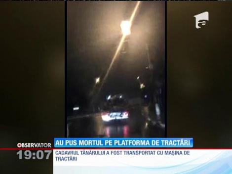 Imagini şocante! Trupul fără viaţă al unui tânăr, dus la morgă pe o platformă pentru autoturisme!