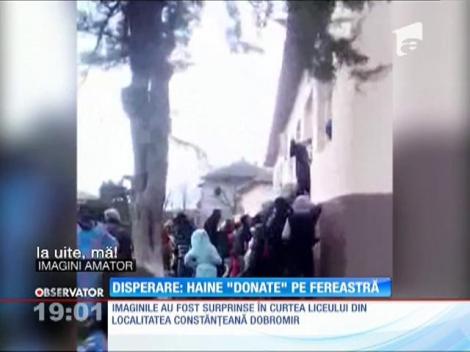 Îmbrânceli la ajutoare. Zeci de copii şi adulţi au ”luptat” ca să prindă măcar o haină