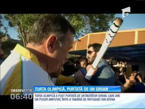 Torţa olimpică şi-a început călătoria lungă spre Rio într-o tabără de refugiaţi din Atena, unde a fost purtată de un înotător sirian, care are un picior amputat
